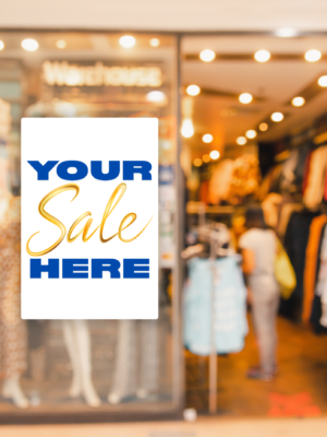 Custom retail window poster reading “Your Sale Here” displayed on a Houston boutique storefront glass with blurred clothing racks and a shopper browsing inside.